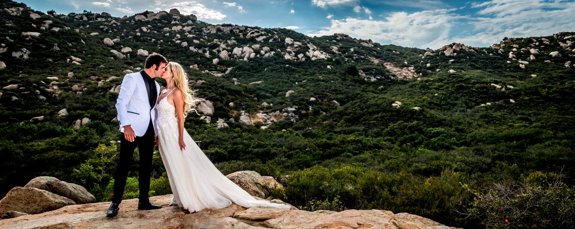 Bride and groom on top of cliff at Aviation Vineyards in Temecula. 