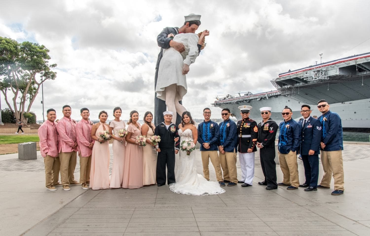 Bridal party in front of the kissing statue. 