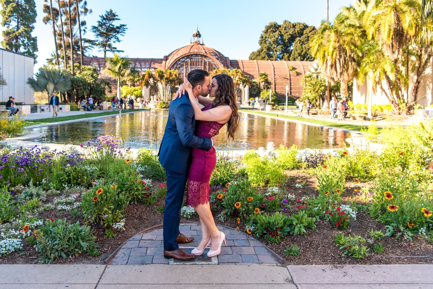Bride and groom kissing in front of the Lily Pond at Balboa Park. 