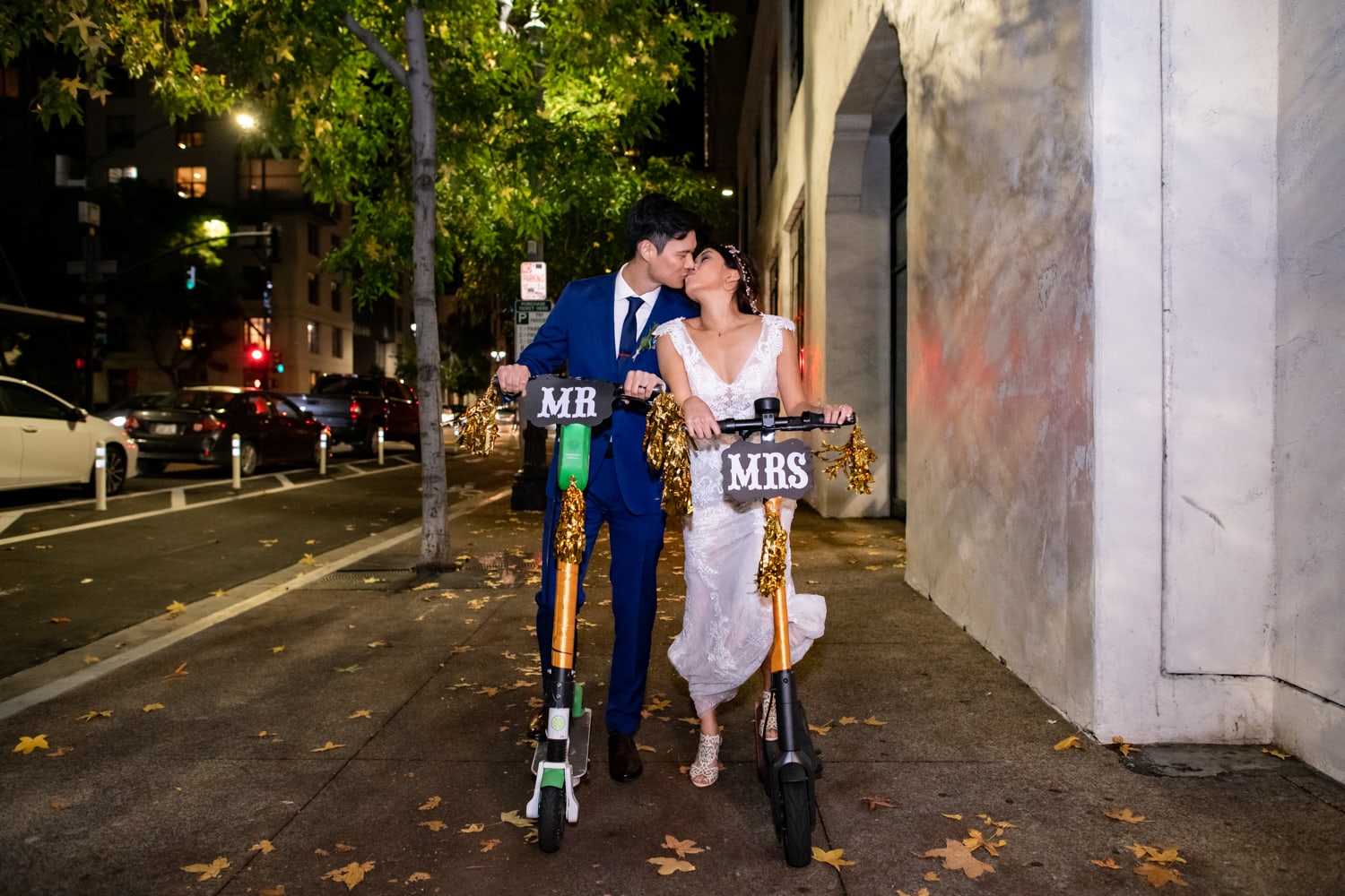 Bride and Groom on decorated bird scooters for their grand entrance at Luce Loft.