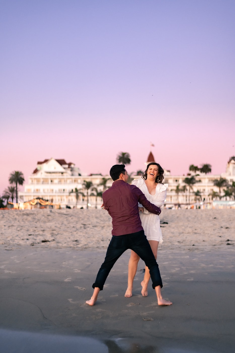 Girl running to her fiance on the beach at Hotel Del Coronado.